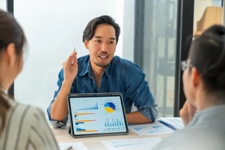 Man talking about data with colleagues.