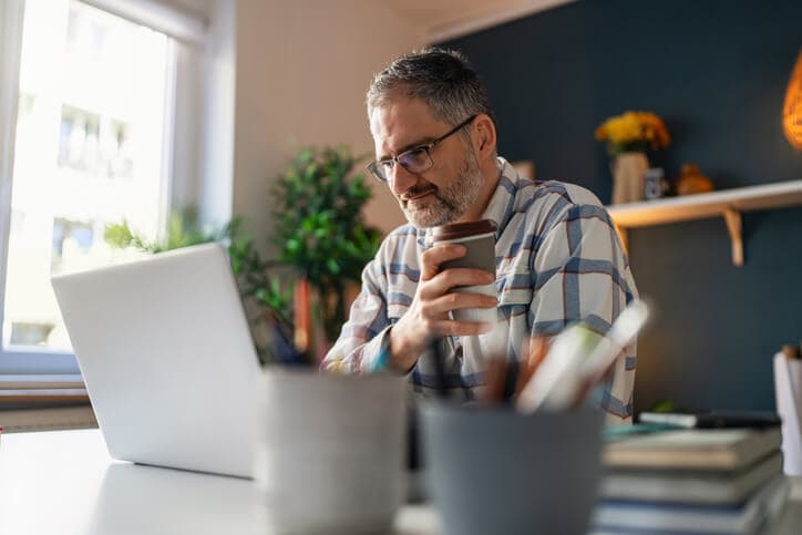 Mature Caucasian man working at his home office.