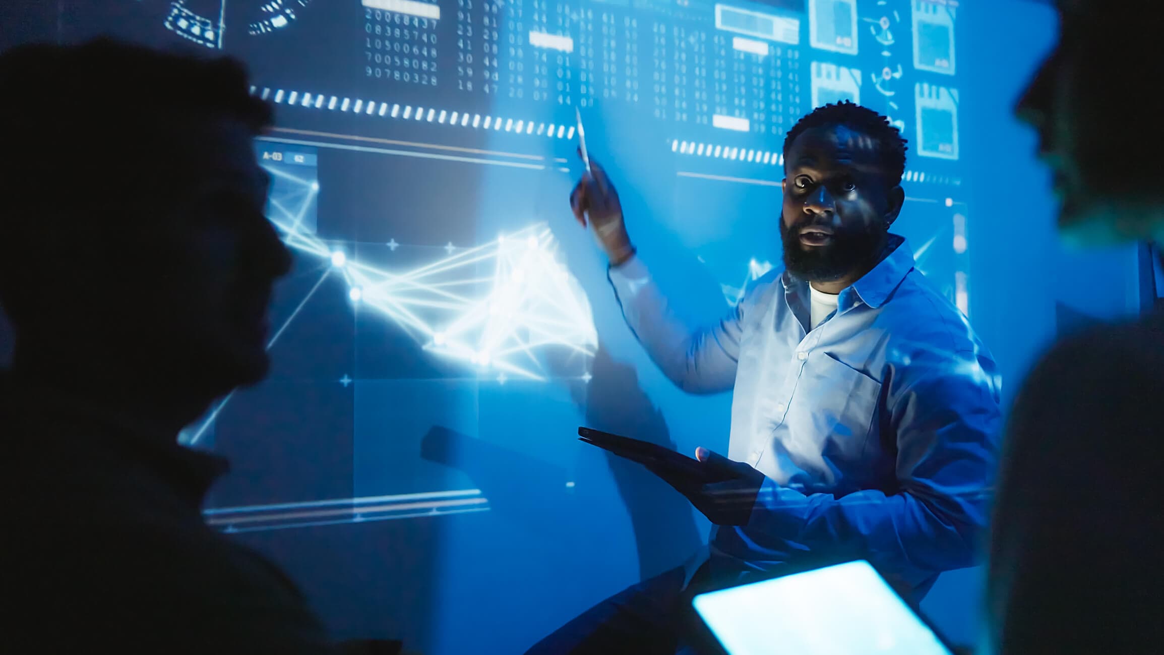 Software engineering team meeting to review code and enhance the capabilities of their product's technology with artificial intelligence and blockchain.