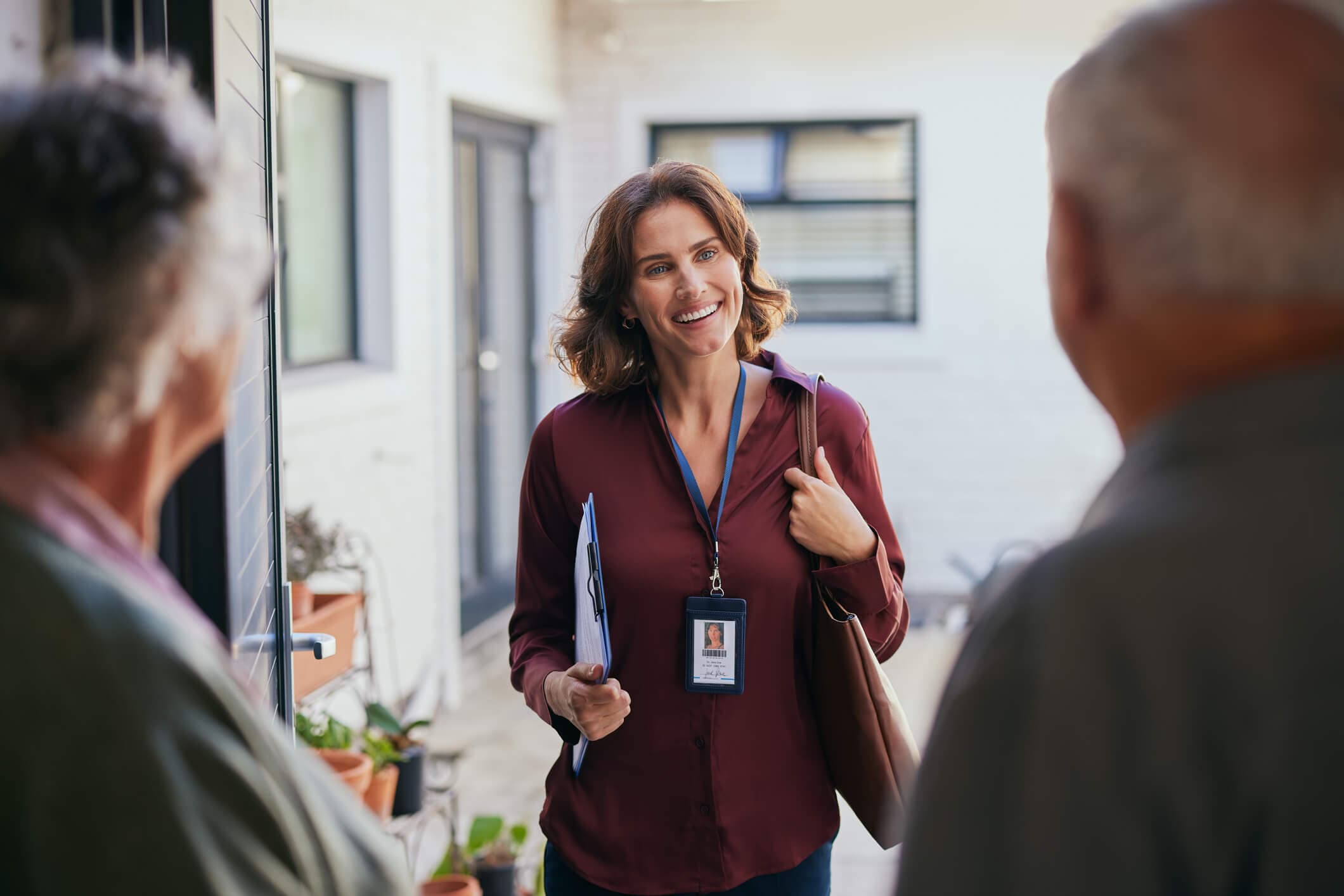 Mid adult social worker visiting an elderly couple at home.