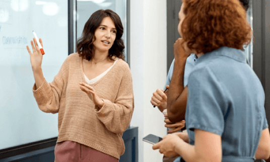 Woman having a conversation with two other people.